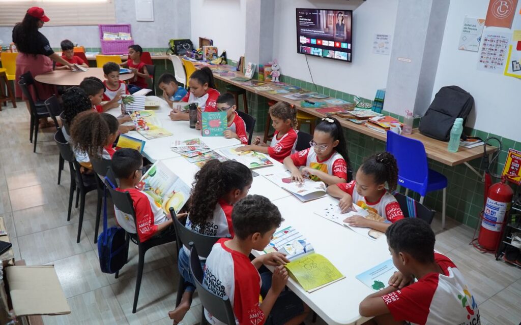 Children engaged in reading at a community library in Glória do Goitá, Brazil.
