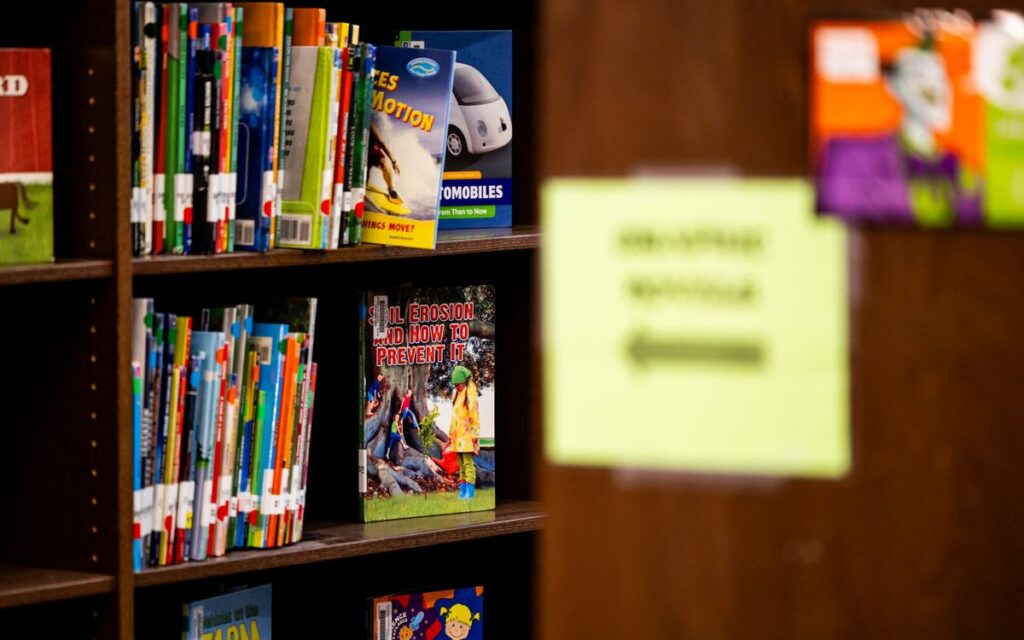 A library shelf filled with colorful children's books, focused on educational topics.