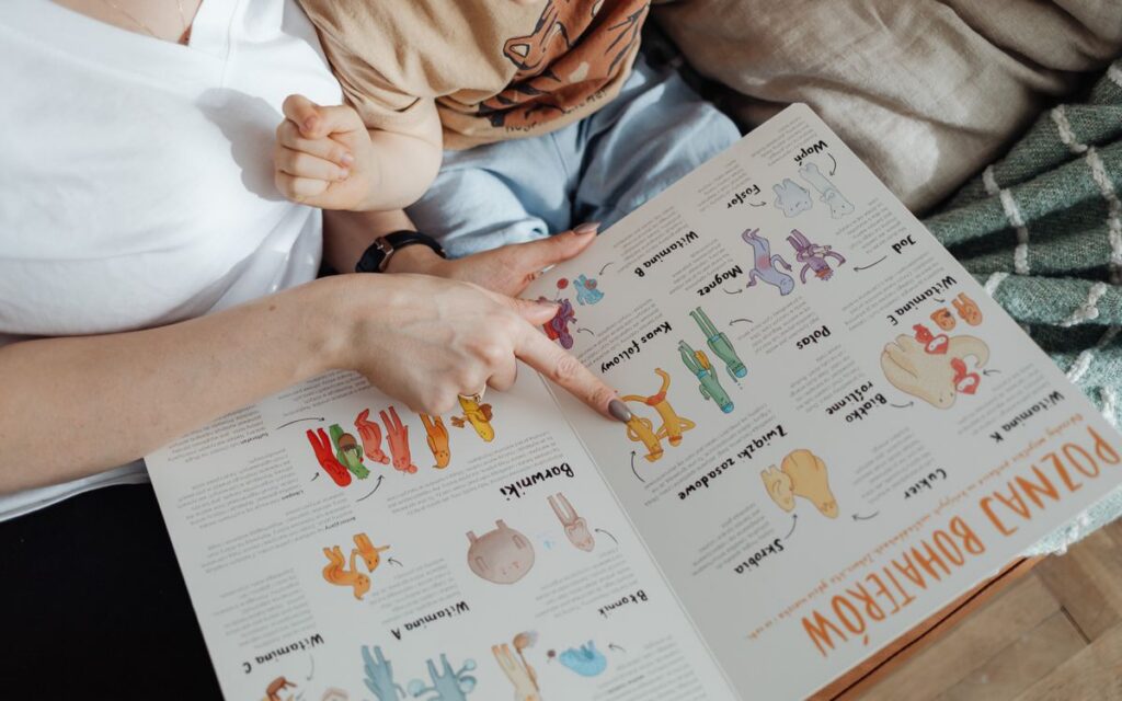 A comforting moment of a mother reading a colorful picture book with her child.