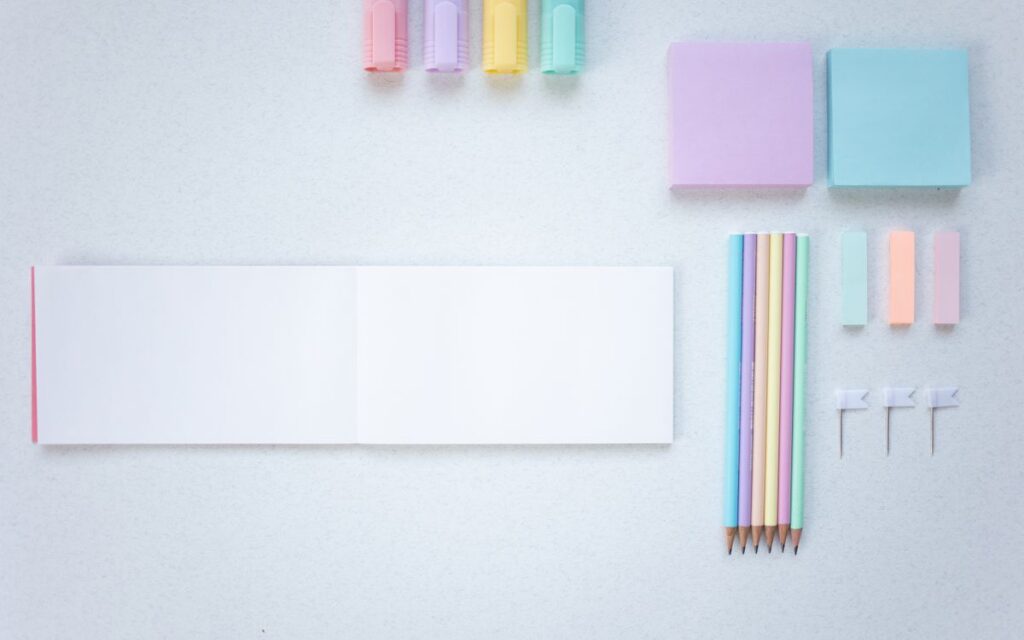 Flat lay of colorful stationery on a white background. Perfect for office and school supplies photography.