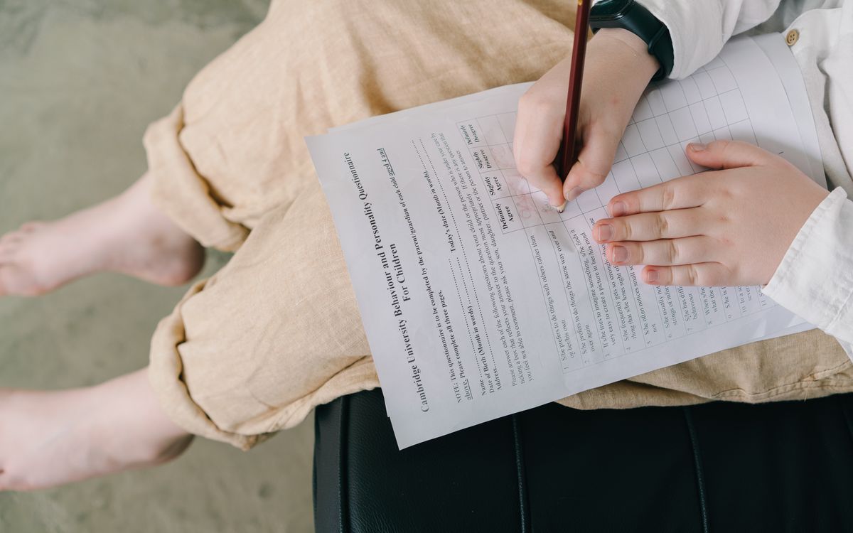 Young child completing a questionnaire indoors for educational purposes.