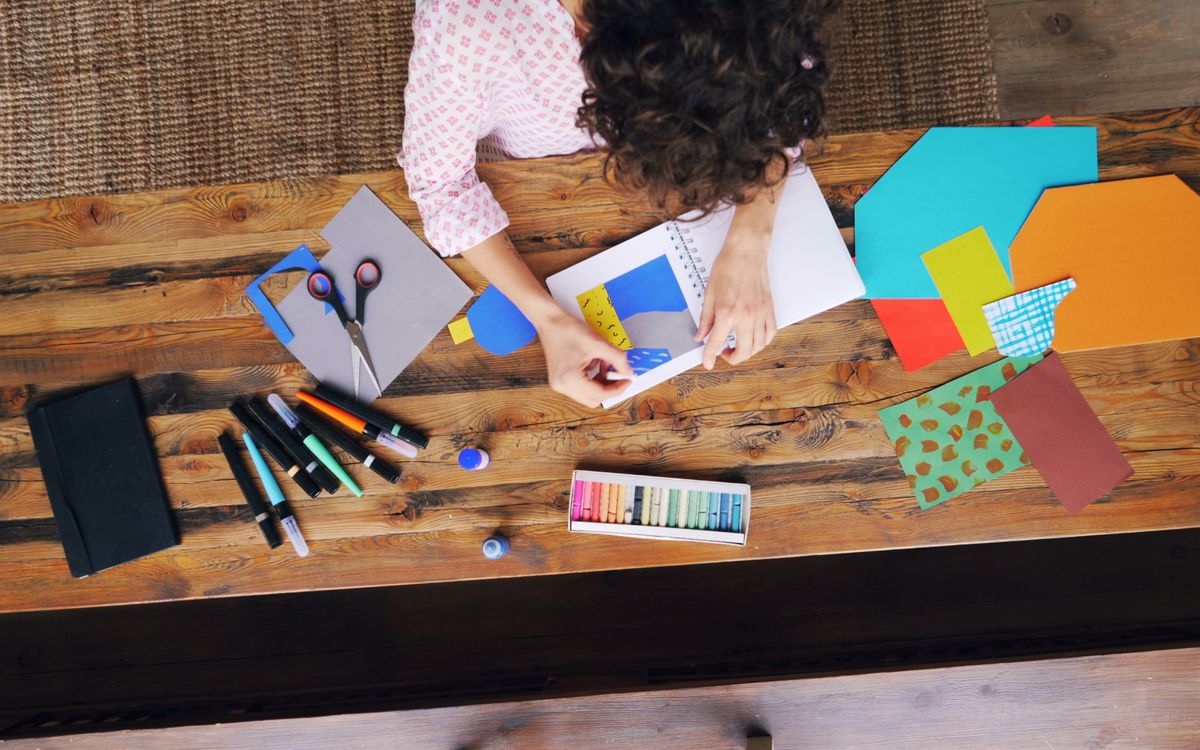 Crafting station view from above showing art supplies and creative process.